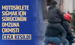 Motosiklete sığmak için sürücünün omzuna çıkmıştı: Ceza kesildi