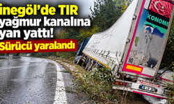 İnegöl’de TIR yağmur kanalına yan yattı! Sürücü yaralandı