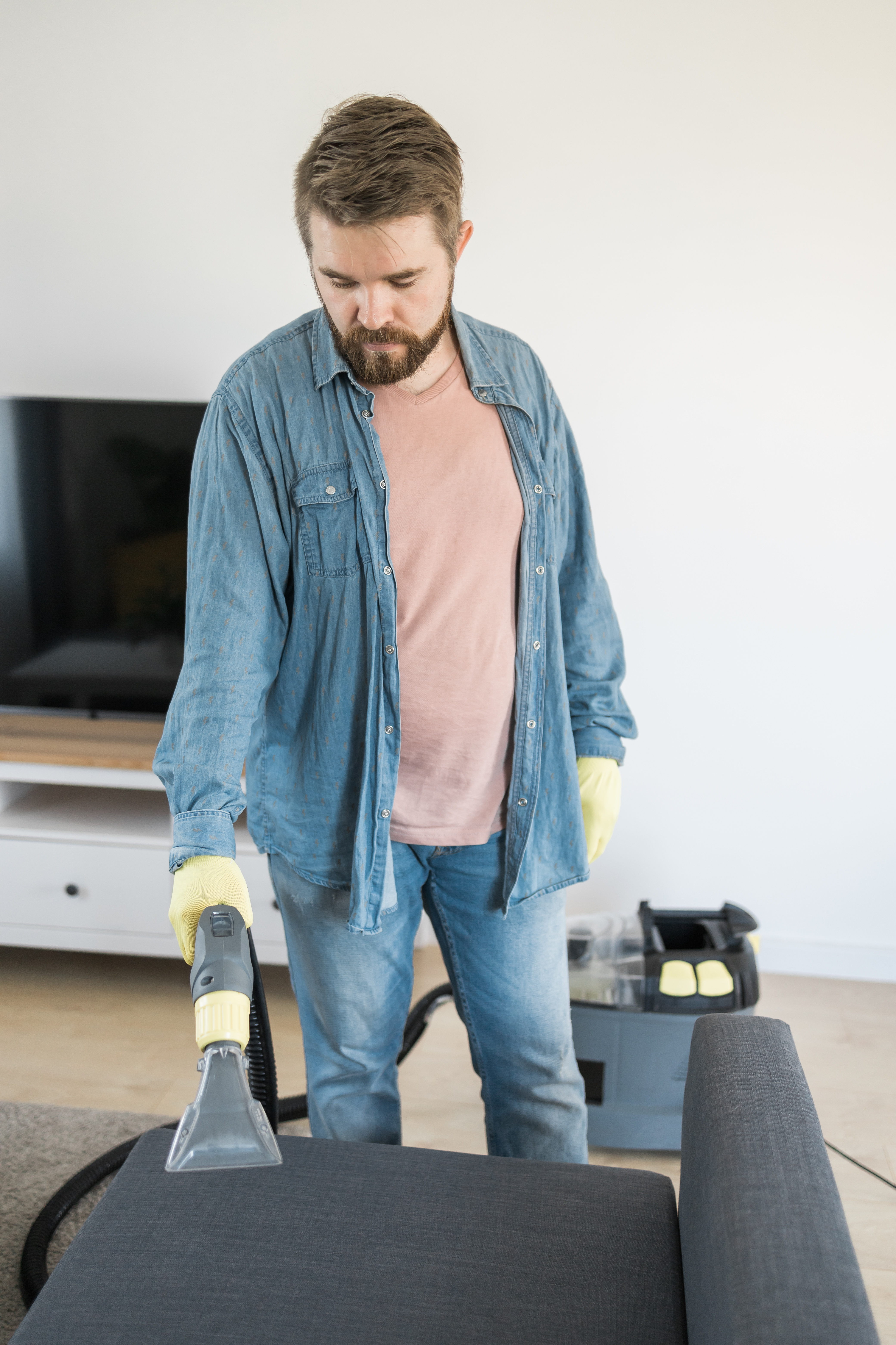 man-dry-cleaner-s-employee-hand-protective-rubber-glove-cleaning-sofa-with-professionally-extraction-method-early-spring-regular-cleanup-commercial-cleaning-company-concept