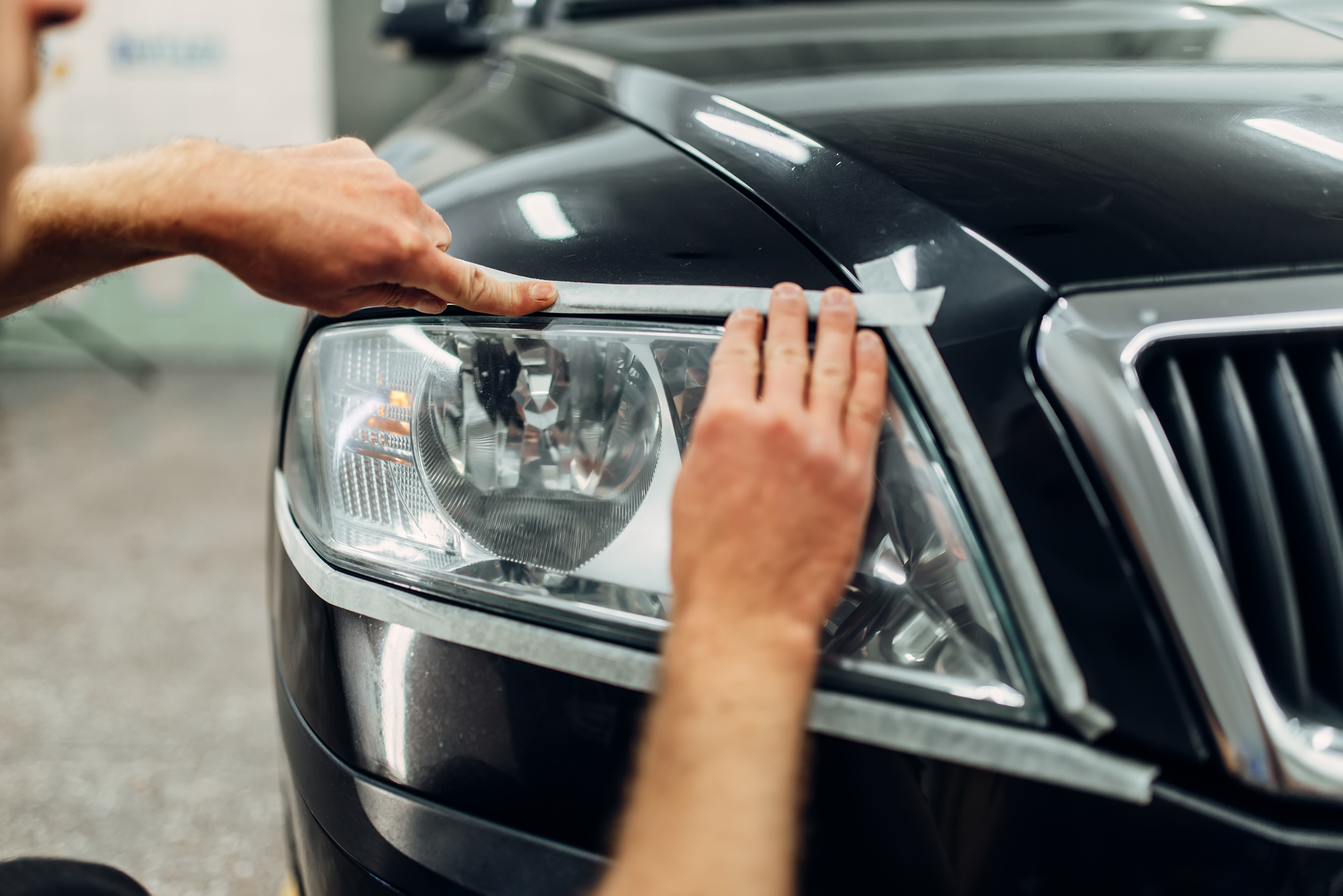 auto-detailing-car-headlights-carwash-service-worker-prepares-glass-polishing