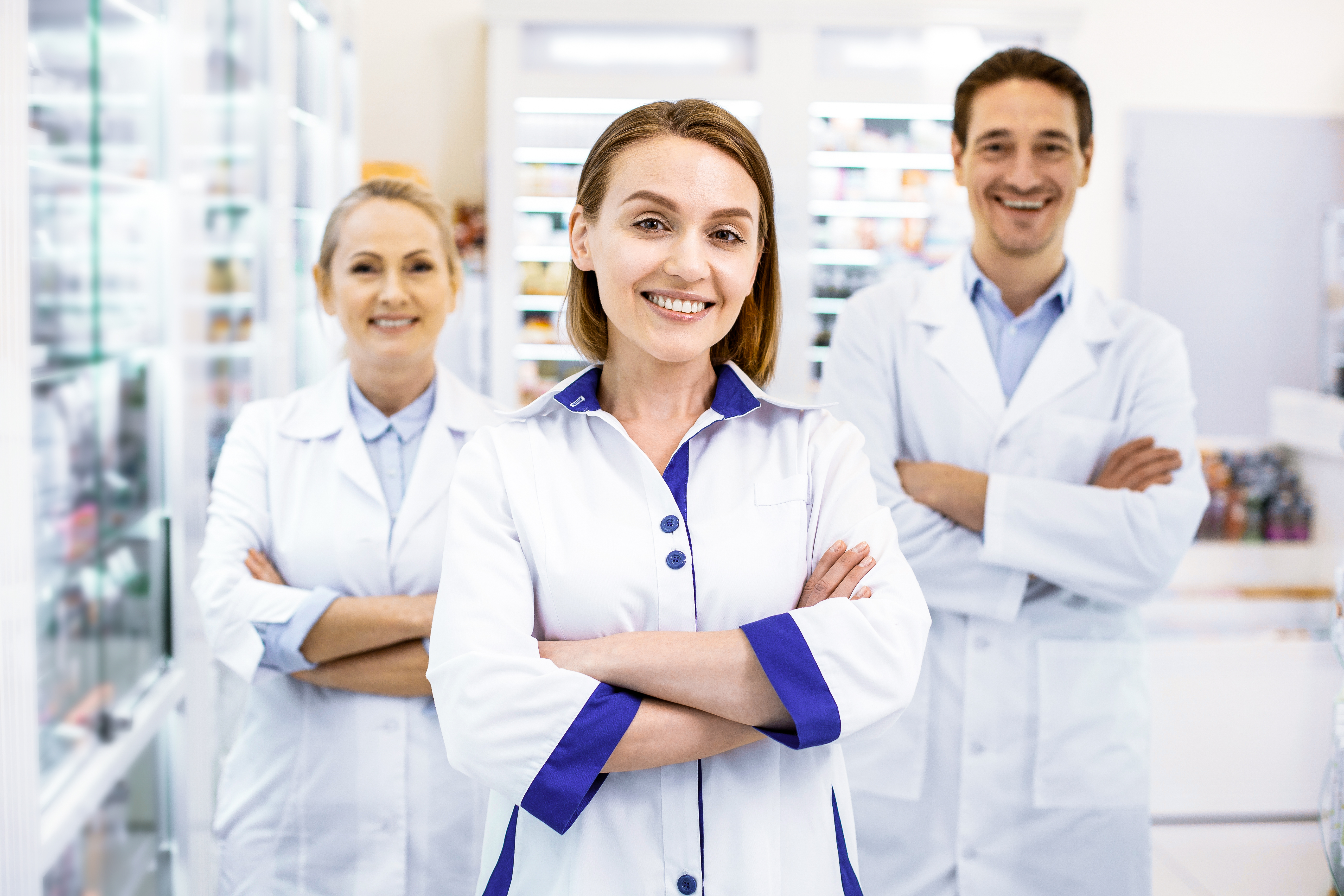 cheerful-reliable-three-pharmacists-standing-arms-crossed-ready-advise-provide-services