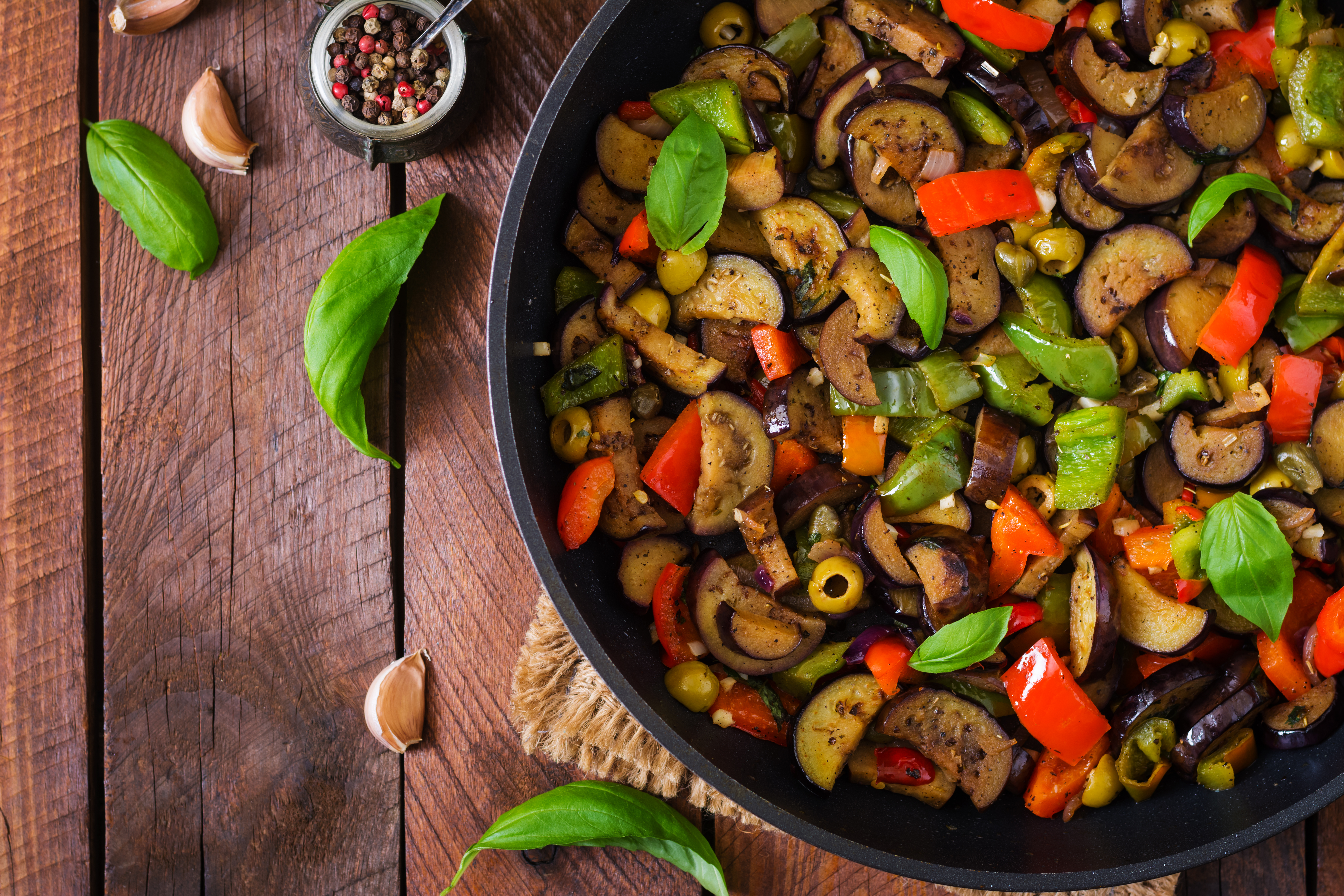 hot-spicy-stew-eggplant-sweet-pepper-olives-capers-with-basil-leaves-top-view