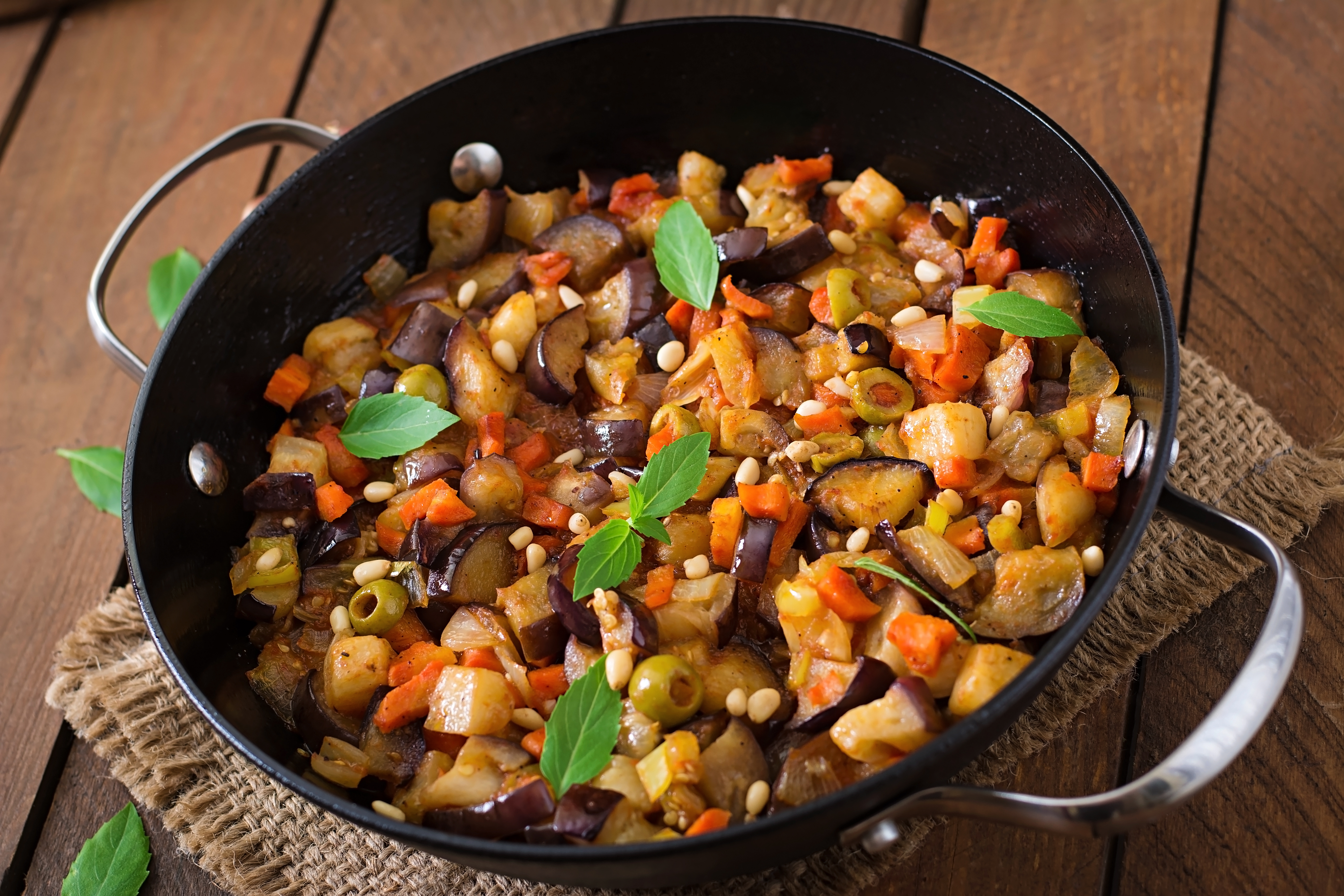 italian-caponata-with-frying-pan-wooden-table