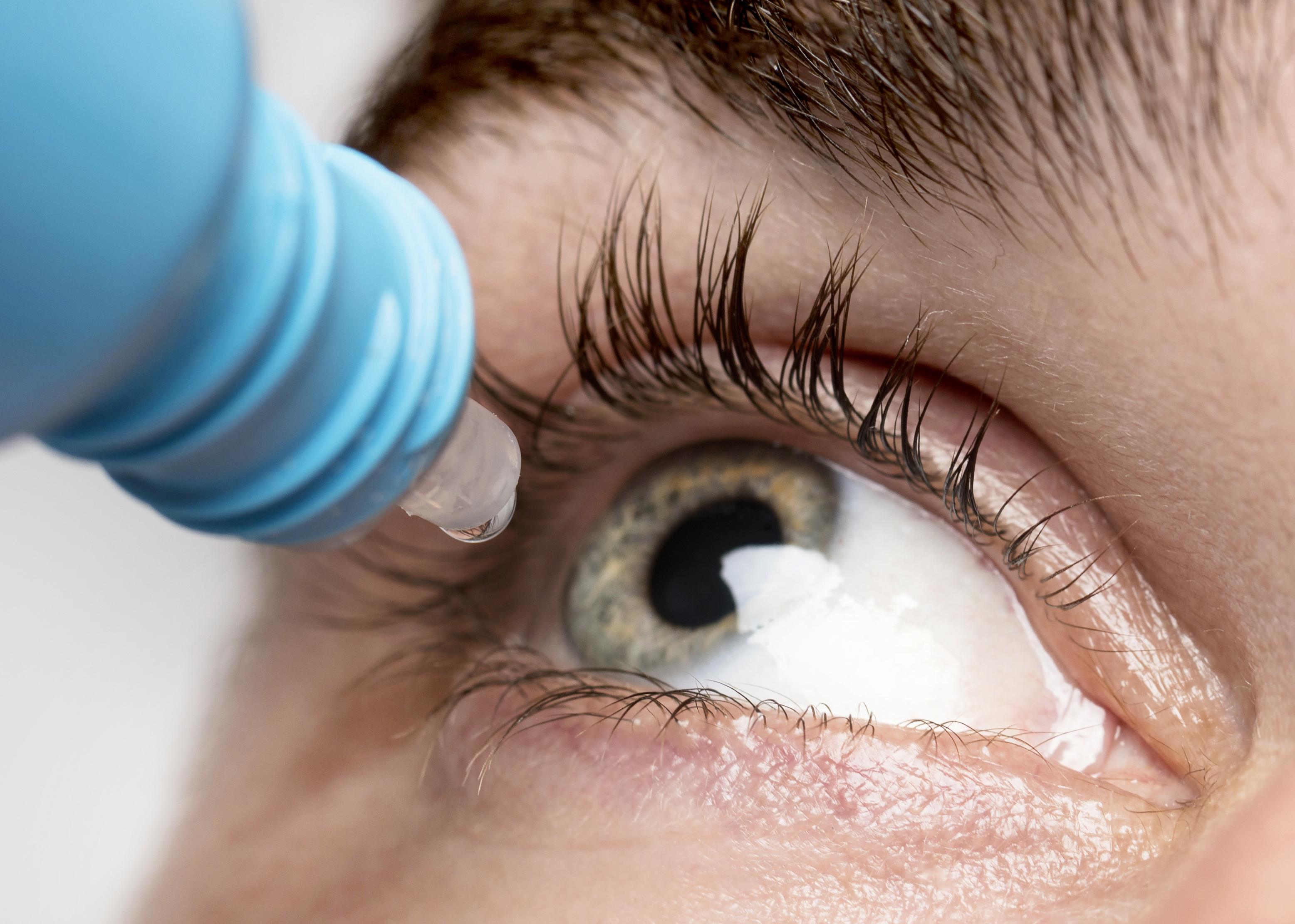 man-using-eye-drops-close-up