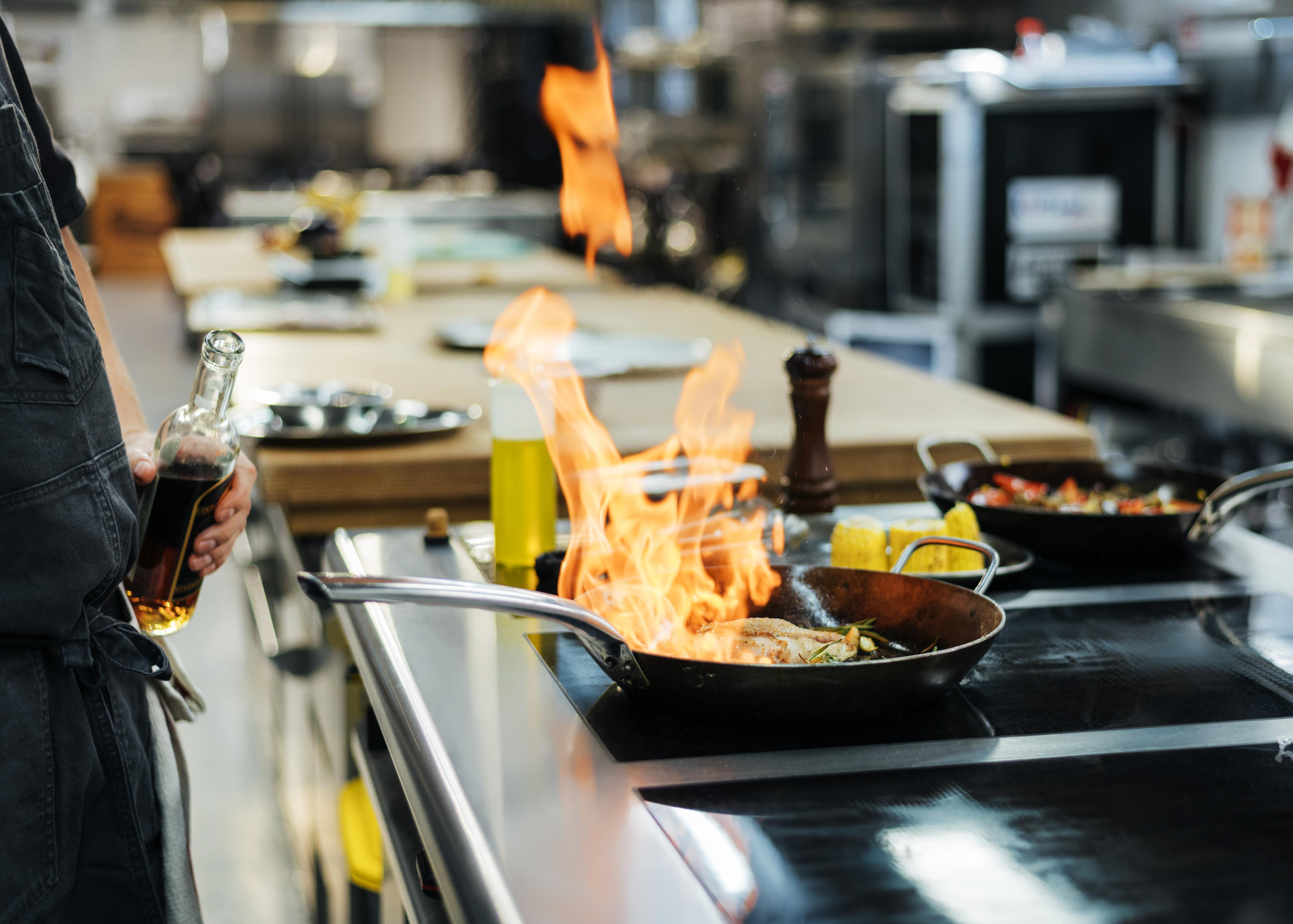 side-view-chef-flambeing-dish-kitchen