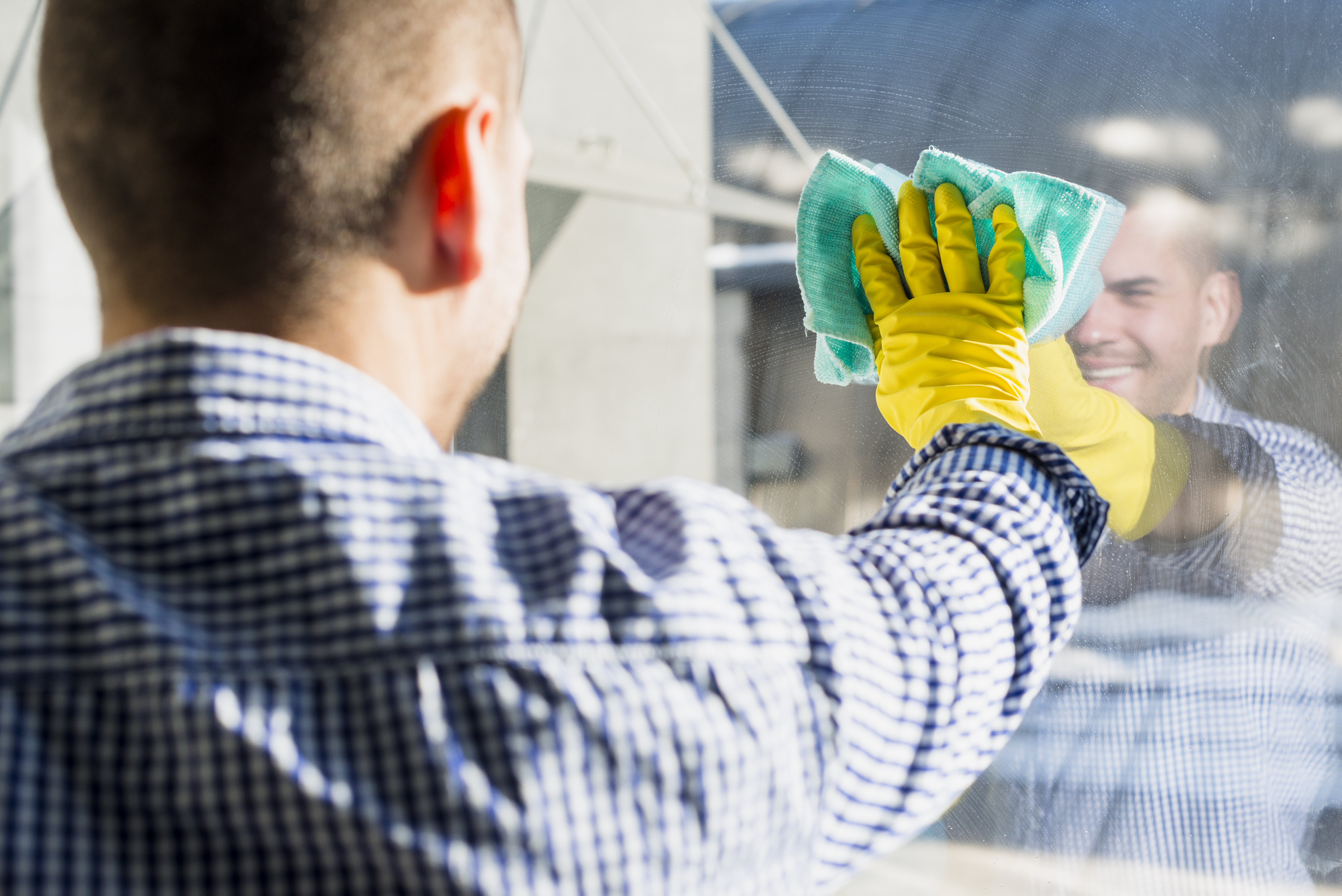 close-up-man-cleaning-his-house