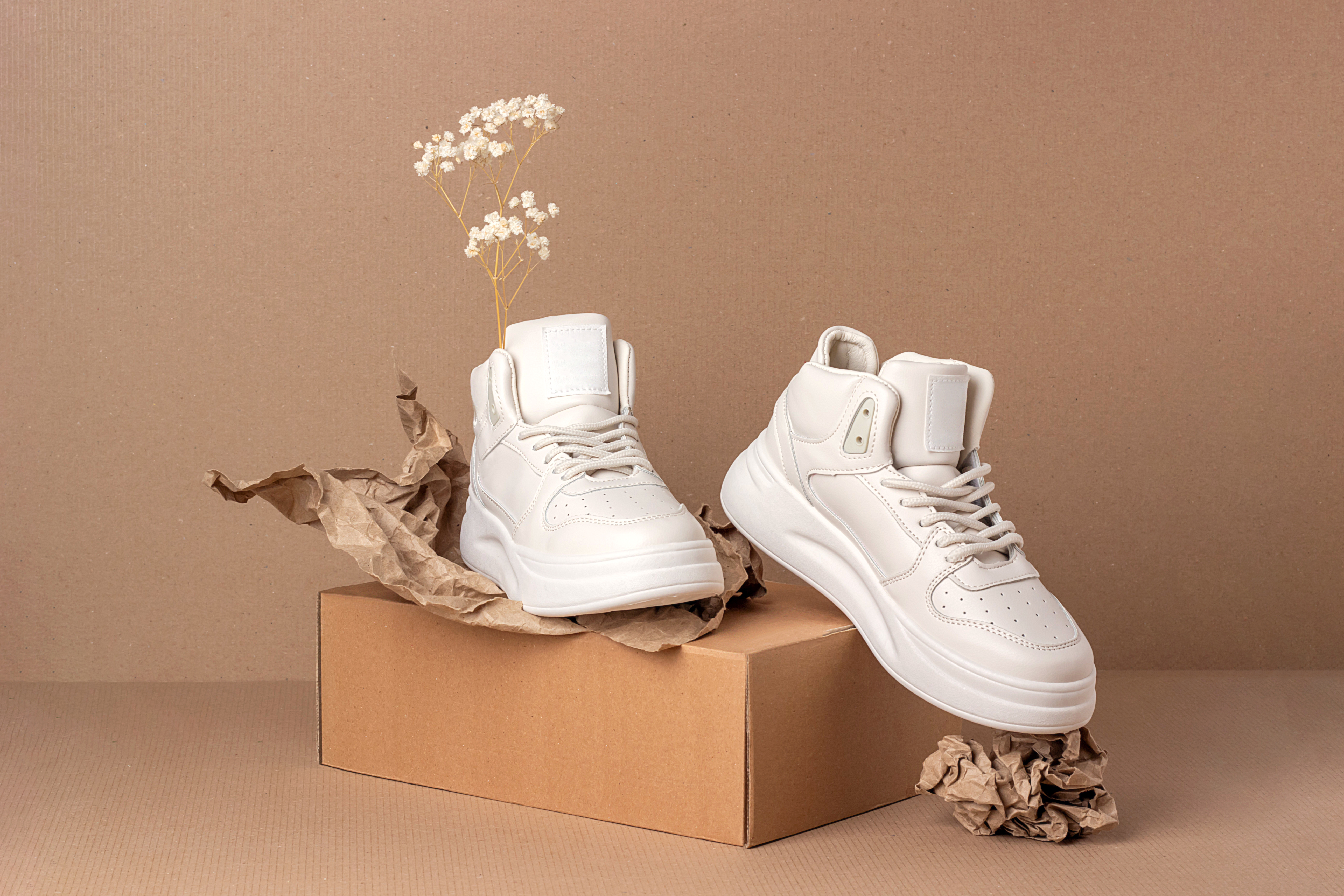 eco-leather-shoes-pair-beige-sneakers-with-dry-flowers-brown-background-casual-sport-lifestyle-concept