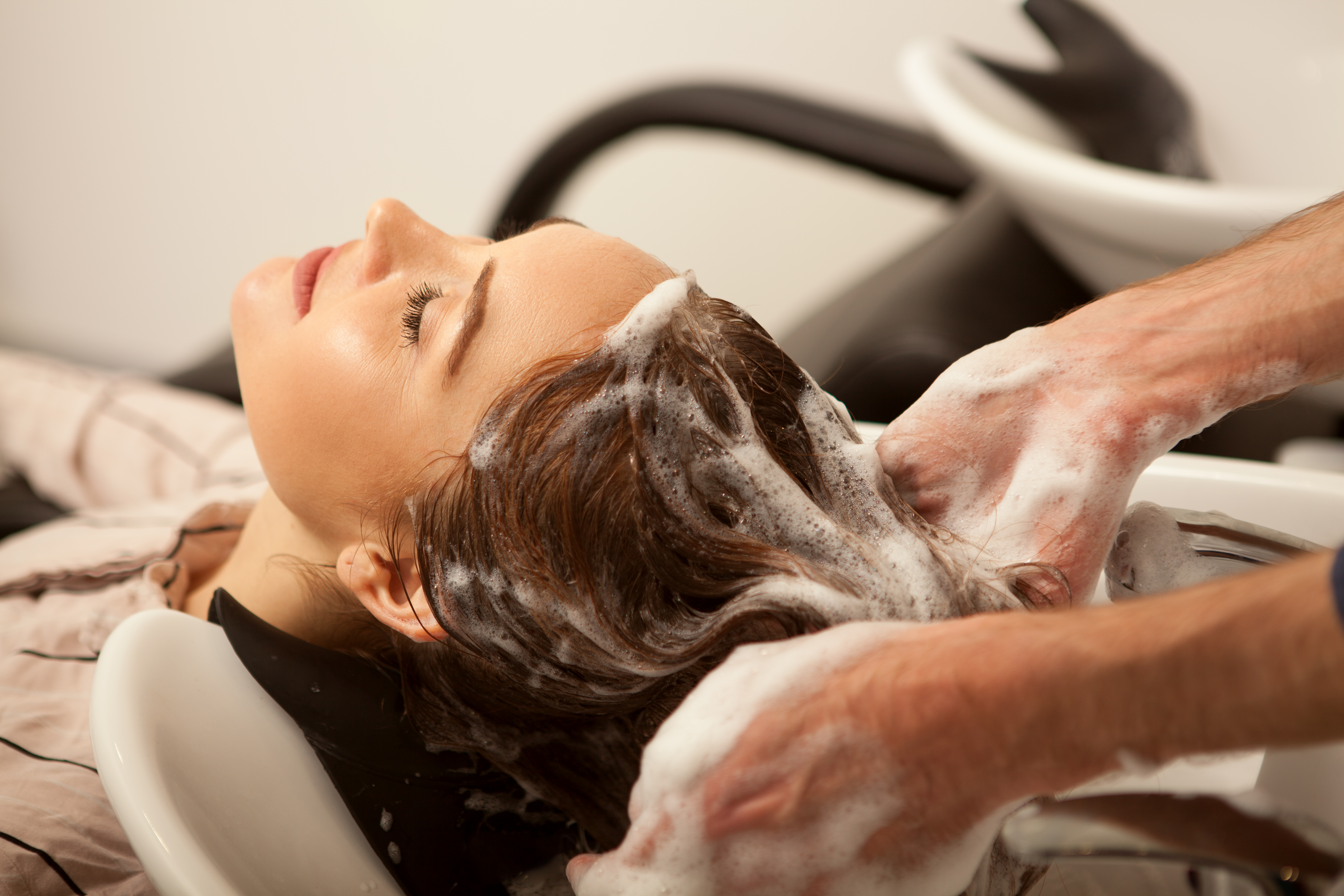 gorgeous-woman-having-her-hair-washed-by-hairdresser