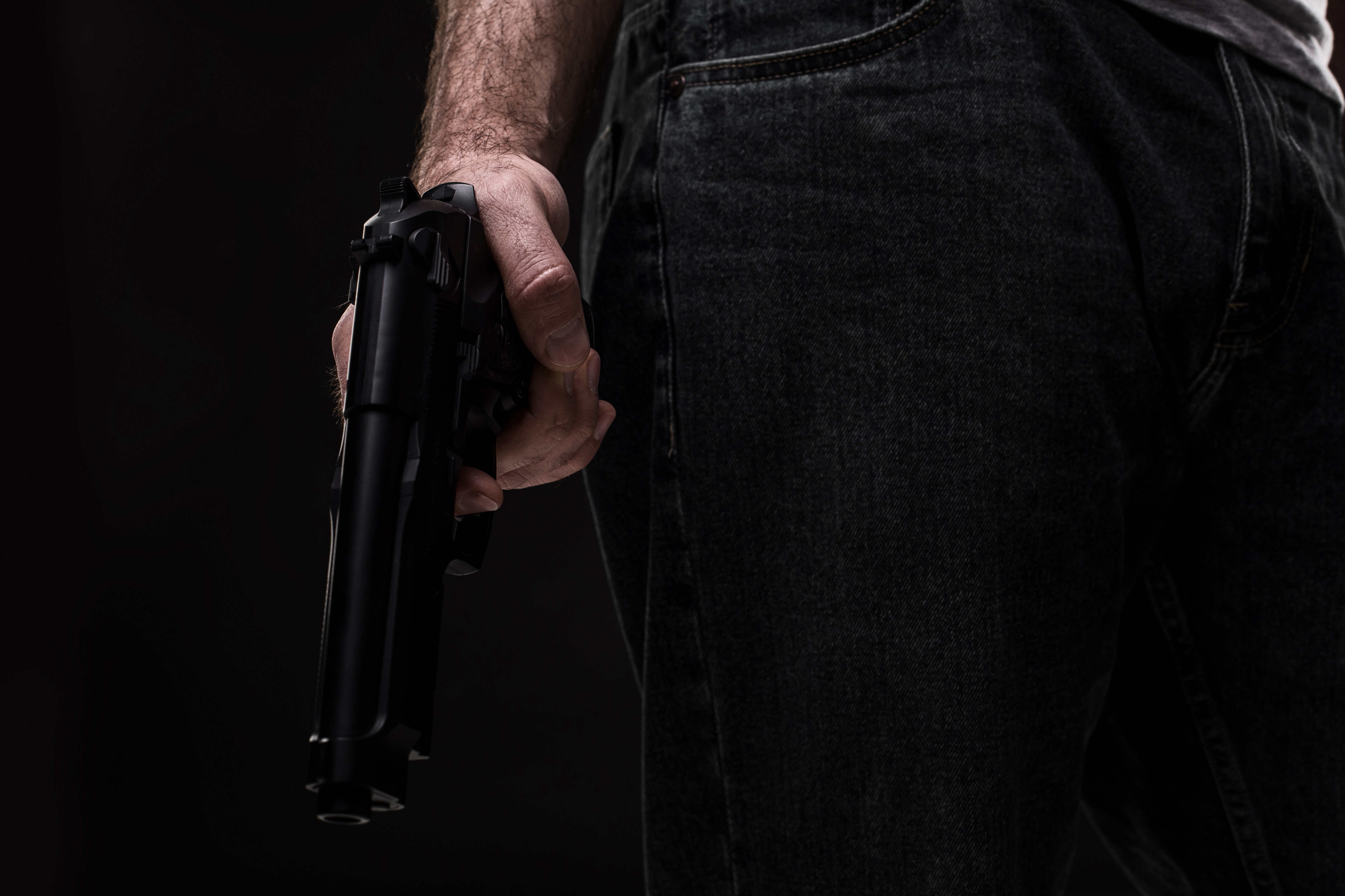 killer-with-gun-black-background-studio