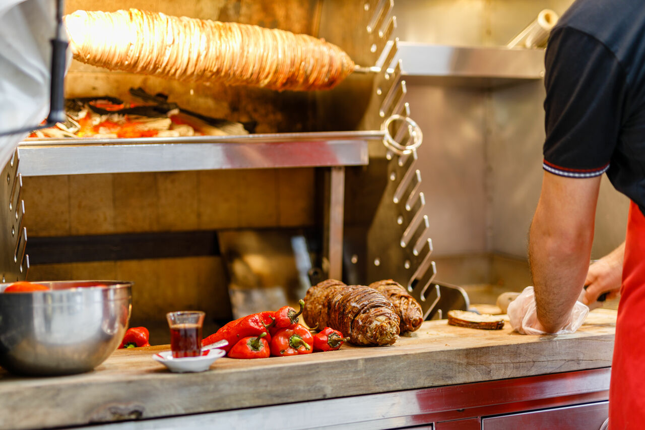 making-turkish-street-food-kokorec-rolls-made-with-lamb-bowel-roasting-wood-fired-oven