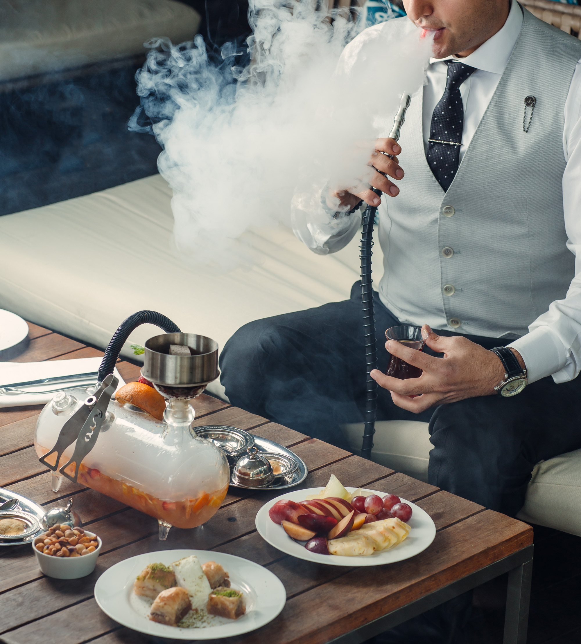 man-smoking-fruit-hookah-from-pipe-shisha-lounge