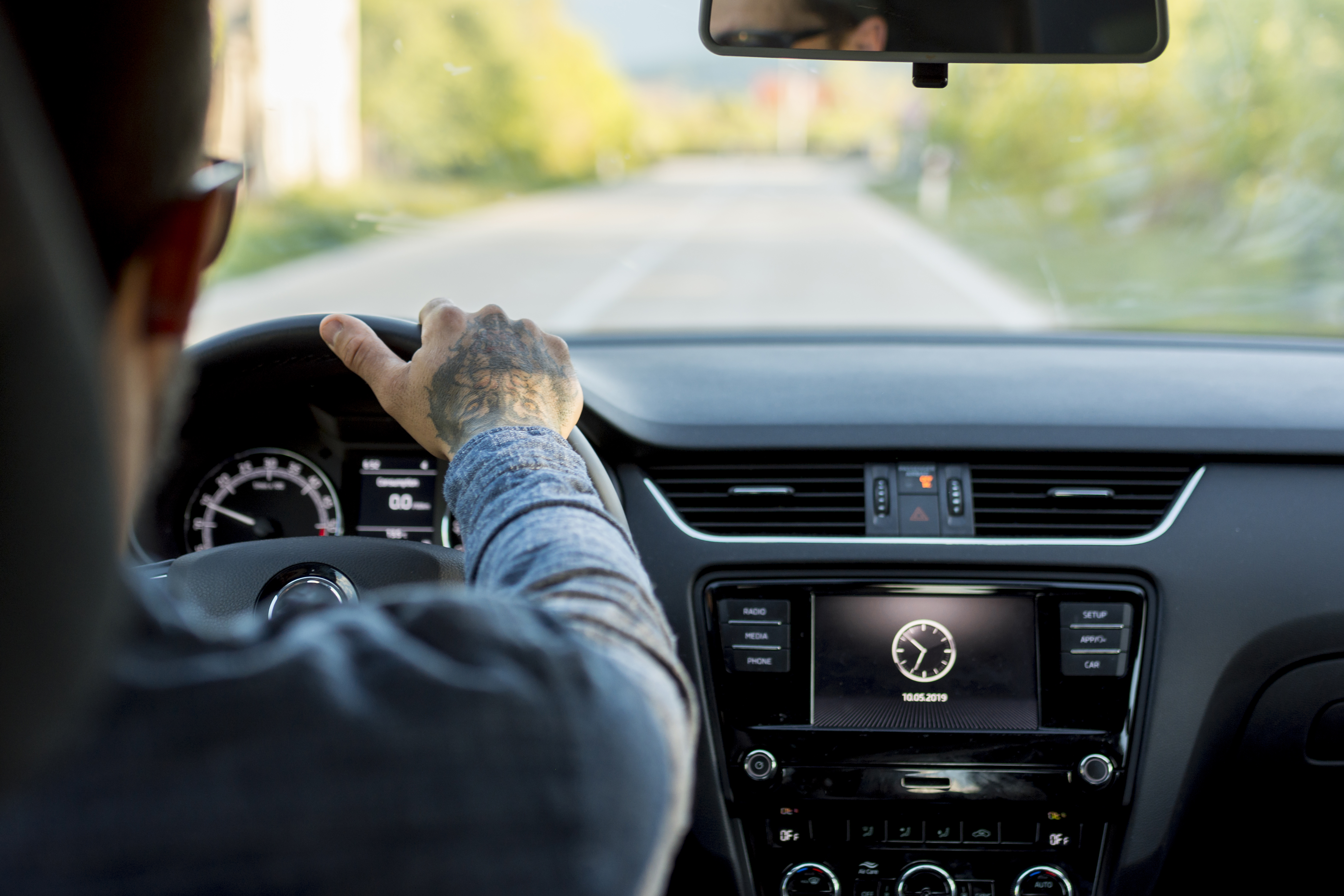 man-with-sunglasses-driving-automobile