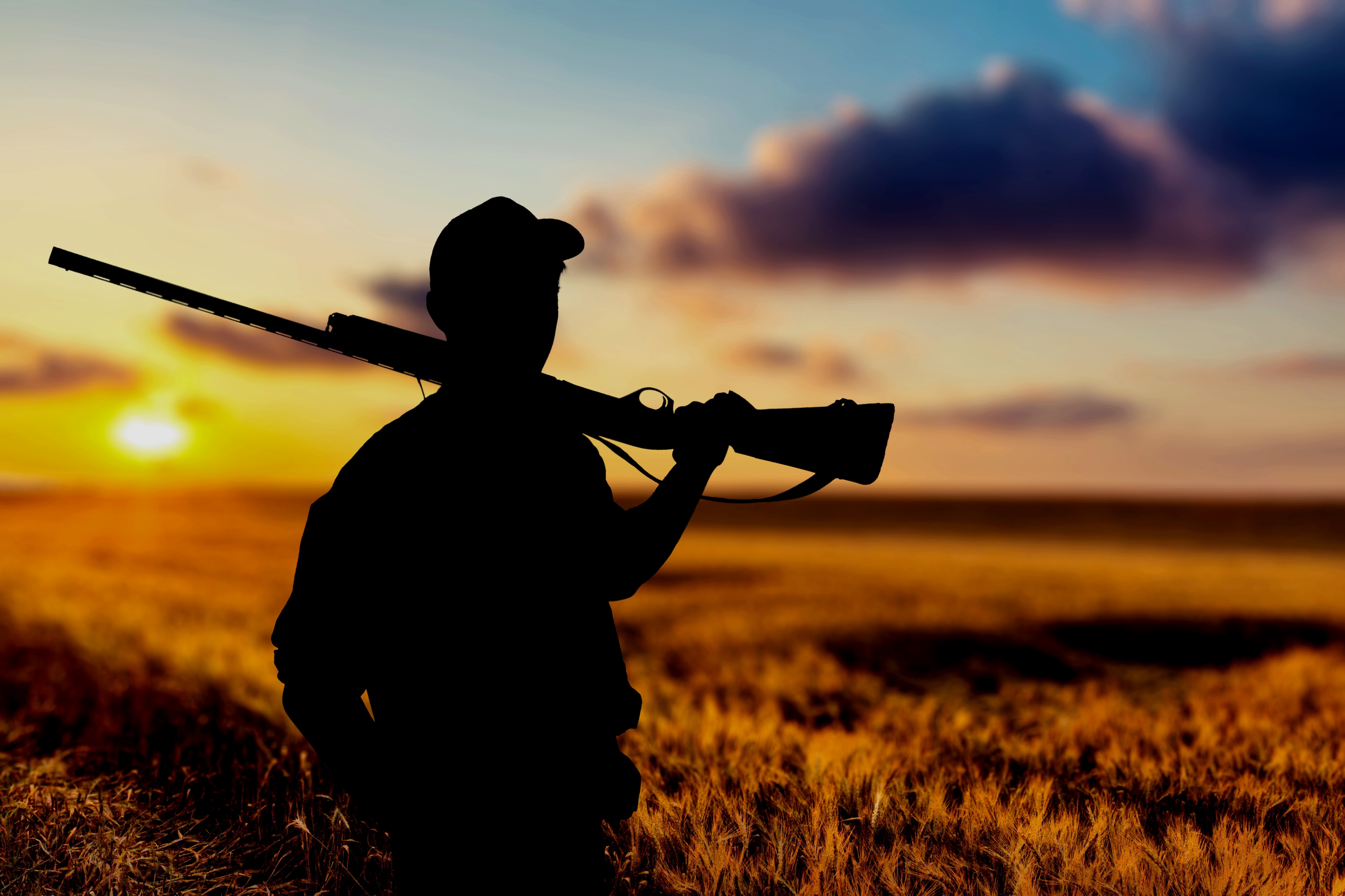 male-hunter-with-rifle-natural-background