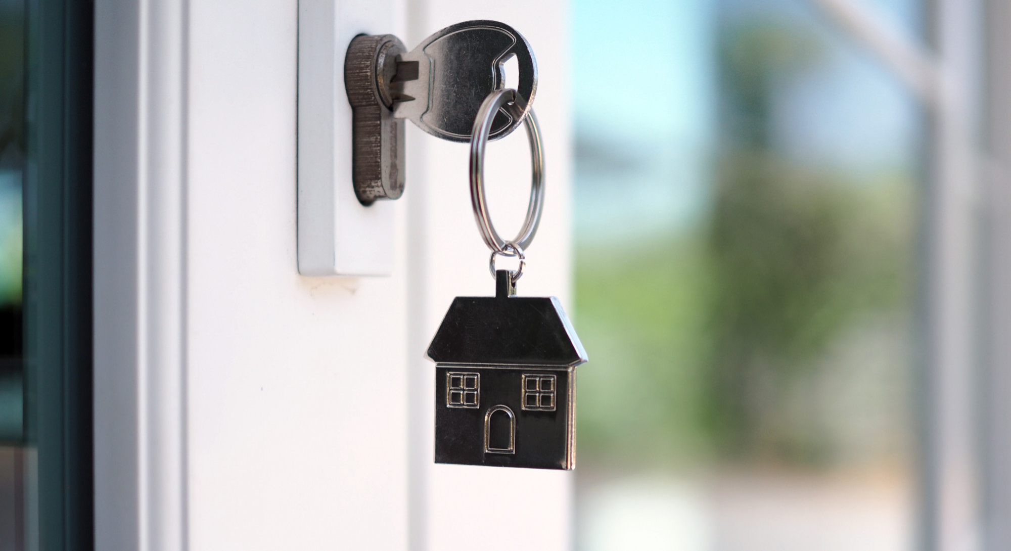 house-key-unlocking-new-house-is-plugged-into-door