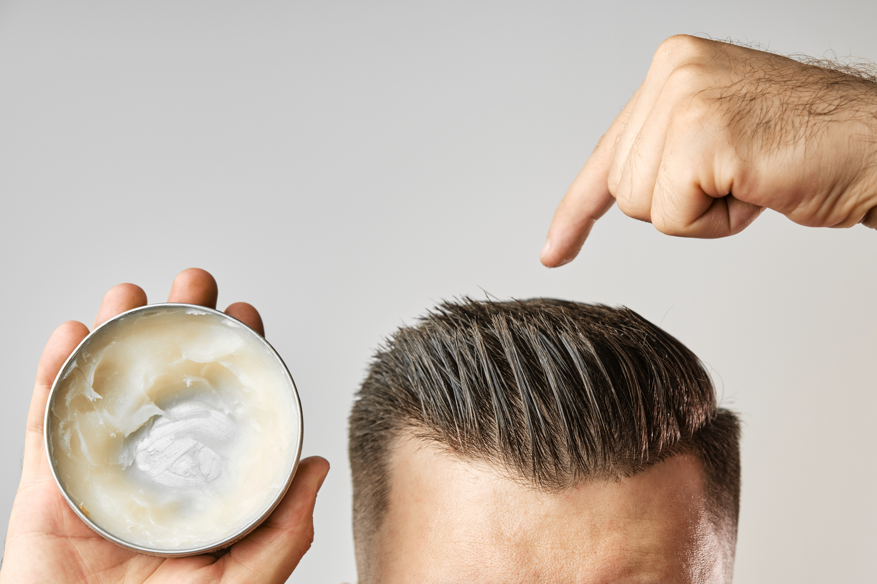 Man Applying A Clay Pomade Wax G